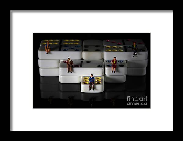 Conceptual Framed Print featuring the photograph miniature people on white colored dominoes Black background macro by Pablo Avanzini