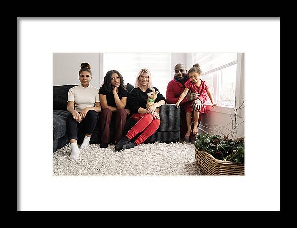 Diversity Framed Print featuring the photograph Mixed-race family portrait in living room. by Martinedoucet