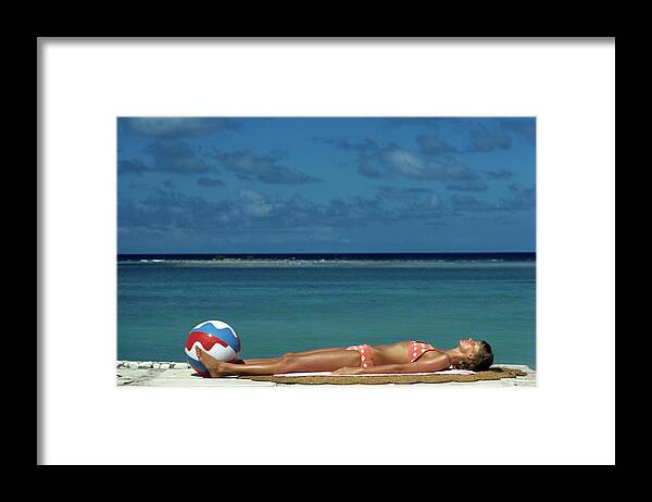 Fashion Framed Print featuring the photograph Model Lying on the Beach in a Polka Dot Bikini by Mike Reinhardt