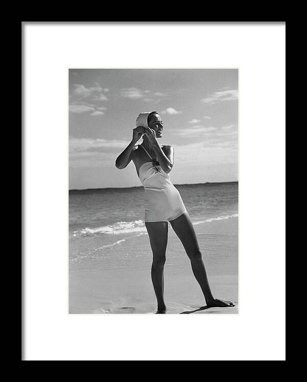 Accessories Framed Print featuring the photograph Model on a Beach Fastening Her Bathing Cap by Toni Frissell