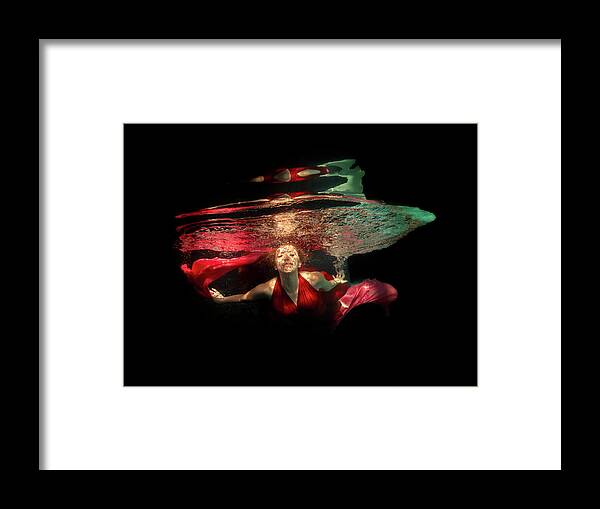 Model Framed Print featuring the photograph Model underwater in pool of light by Dan Friend