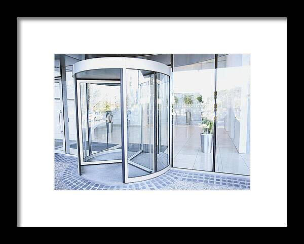 Corporate Business Framed Print featuring the photograph Modern entrance with revolving door by Martin Barraud