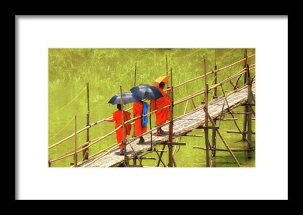 Luang Prabang Framed Print featuring the photograph Monks on the bridge by Robert Bociaga