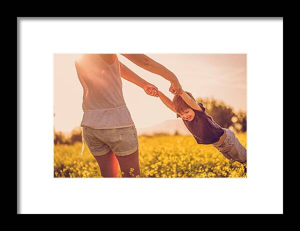 Toddler Framed Print featuring the photograph Mother and baby boy having fun at the field by AleksandarNakic