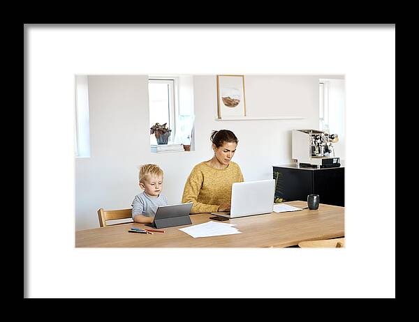 Working Framed Print featuring the photograph Mother and son using technologies at home by Nomad