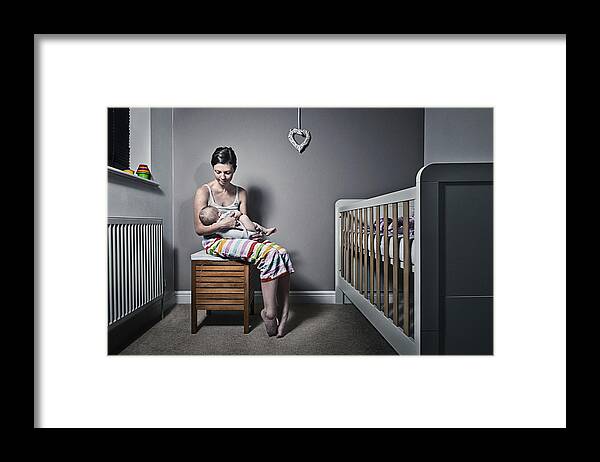 Mid Adult Framed Print featuring the photograph Mother cradling baby by Justin Paget