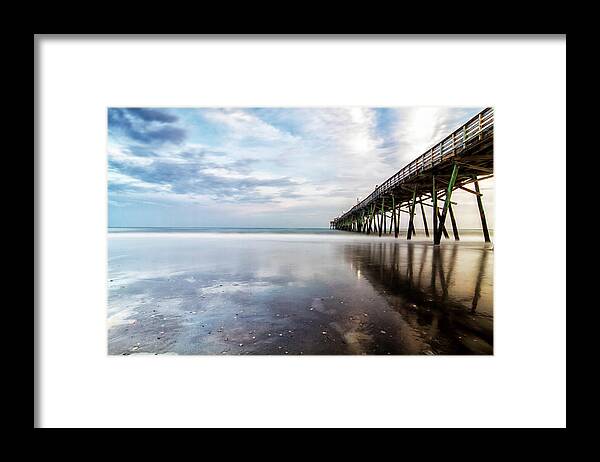 North Carolina Fishing Pier Framed Print featuring the photograph Oceanna Pier With Blue Skies and Dark Clouds Reflected by Bob Decker
