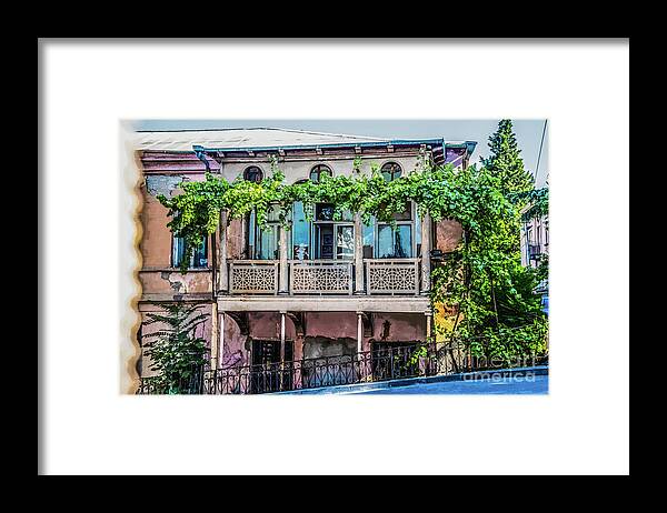 Tiflis Framed Print featuring the photograph Old ornate grungy house in Tbilisi Georgia covered with grape vines by Susan Vineyard