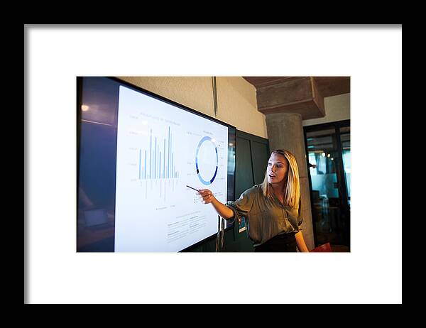 Expertise Framed Print featuring the photograph One young businesswoman making a presentation speech. by Tempura