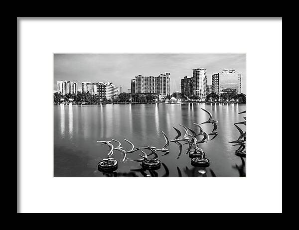 Orlando Skyline Framed Print featuring the photograph Orlando Skyline and Allen Memorial Fountain on Lake Eola - Black and White by Gregory Ballos