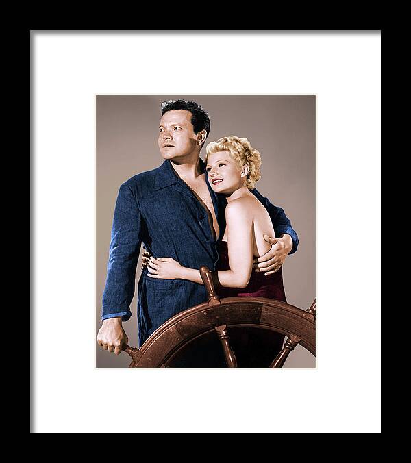 Orson Welles Framed Print featuring the photograph Orson Welles and Rita Hayworth by Movie World Posters