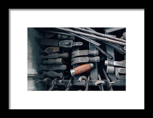 Metalwork Framed Print featuring the photograph Overhead view of blacksmith tongs and hammers in workshop by Mike Tittel