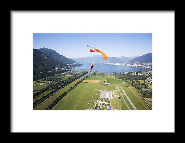 Parachuting Framed Print featuring the photograph Parachutist under canopy flying high in the sky by Oliver Furrer