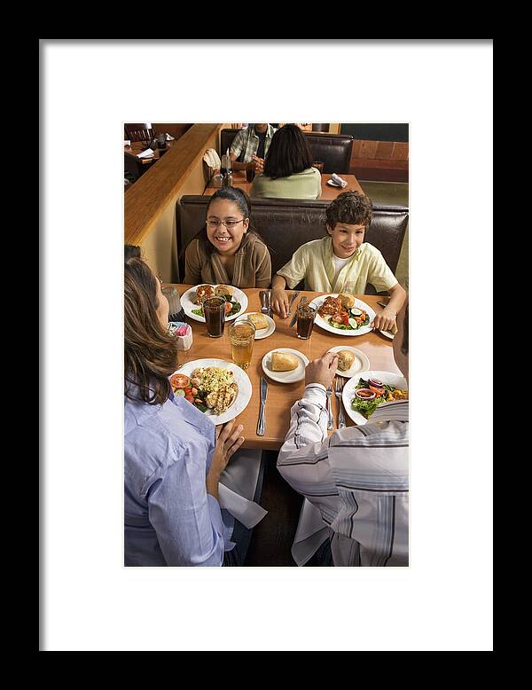 Young Men Framed Print featuring the photograph Parents and children (8-10) dinning in restaurant, high angle view by Yellow Dog Productions