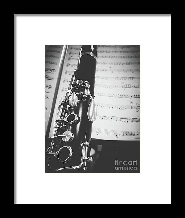 Clarinet Framed Print featuring the photograph Part of a clarinet on musical score black and white by Gregory DUBUS