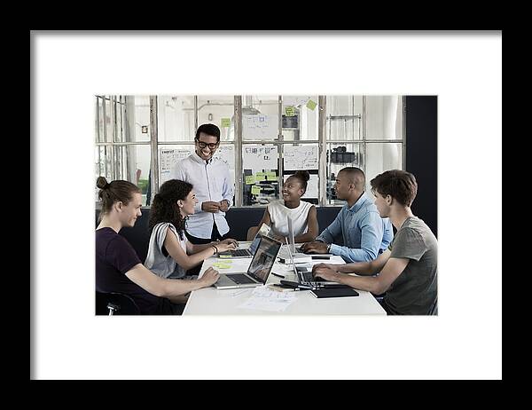 Young Men Framed Print featuring the photograph People having meeting in creative office by Robin Skjoldborg