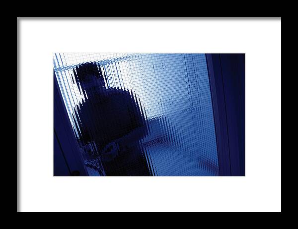 Door Framed Print featuring the photograph Person standing behind the opaque glass of a door by Medioimages/Photodisc
