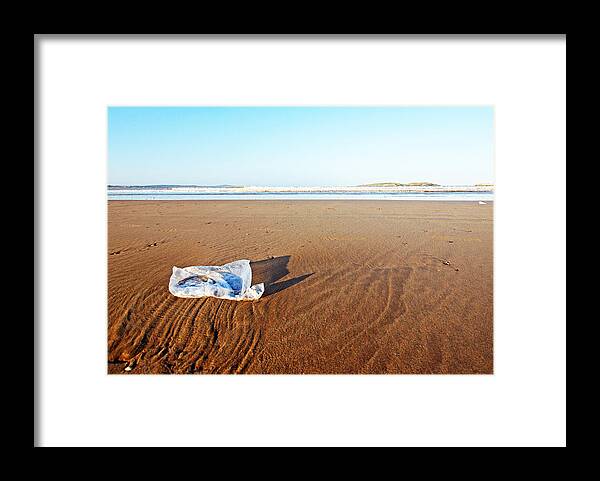 Problems Framed Print featuring the photograph Plastic bag on beach by Rosmarie Wirz
