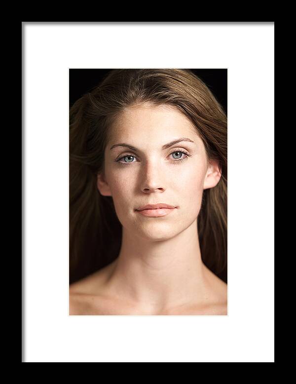 Caucasian Ethnicity Framed Print featuring the photograph Portrait Of Attractive Caucasian Woman With Blue Eyes And Hair Flowing In Wind Looks At Camera by Digital Vision