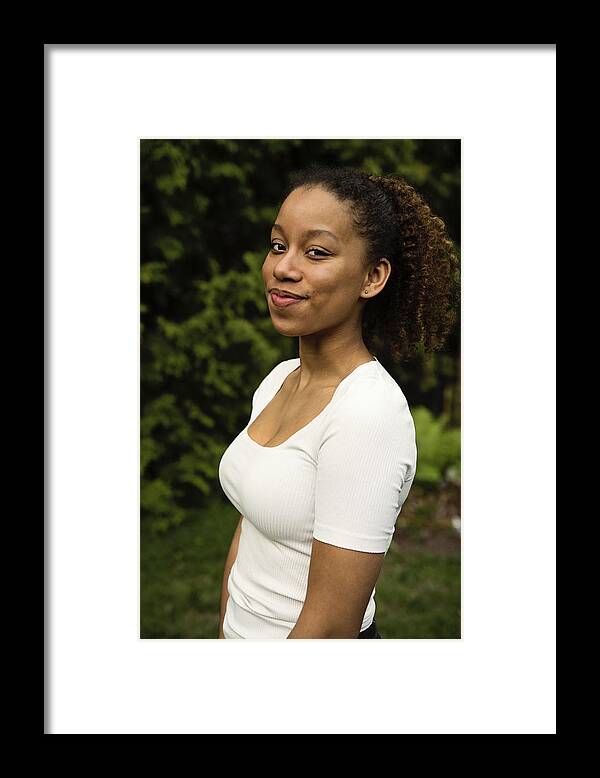 Diversity Framed Print featuring the photograph Portrait of beautiful mixed-race teenage girl in backyard. by Martinedoucet