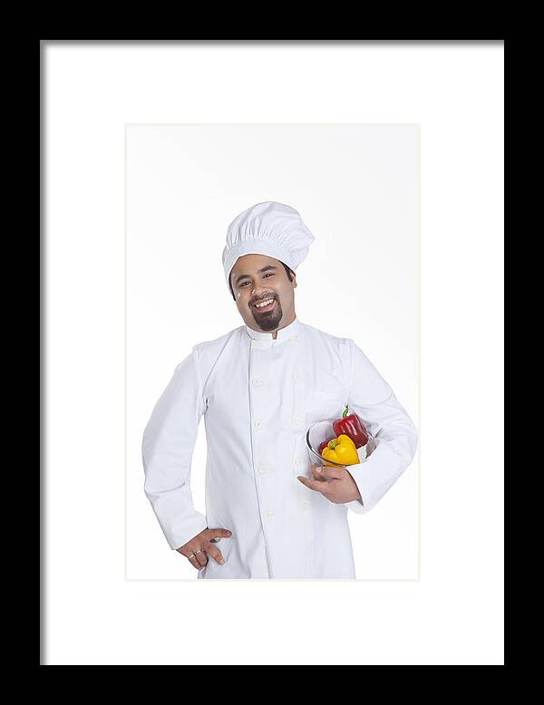 Young Men Framed Print featuring the photograph Portrait of chef with bowl of capsicum by Ravi Ranjan