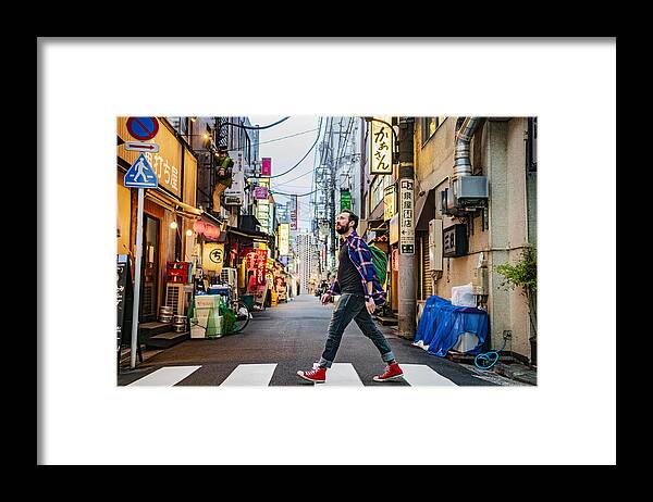 Cool Attitude Framed Print featuring the photograph Portrait of man walking on zebra crossing on Tokyo street by JohnnyGreig
