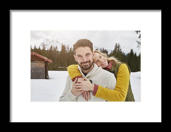 Young Men Framed Print featuring the photograph Portrait of romantic couple in snow, Elmau, Bavaria, Germany by Stephen Lux