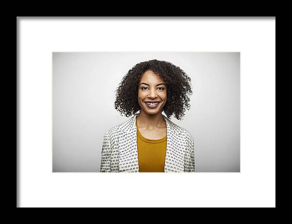 Cool Attitude Framed Print featuring the photograph Portrait Of Smiling Mid Adult Woman In Casuals by Morsa Images