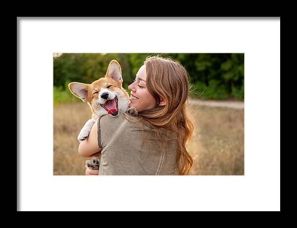 Pets Framed Print featuring the photograph Portrait: young woman with laughing corgi puppy, nature background by Fotografixx