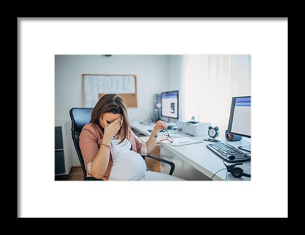 Working Framed Print featuring the photograph Pregnant businesswoman having headache by Hirurg