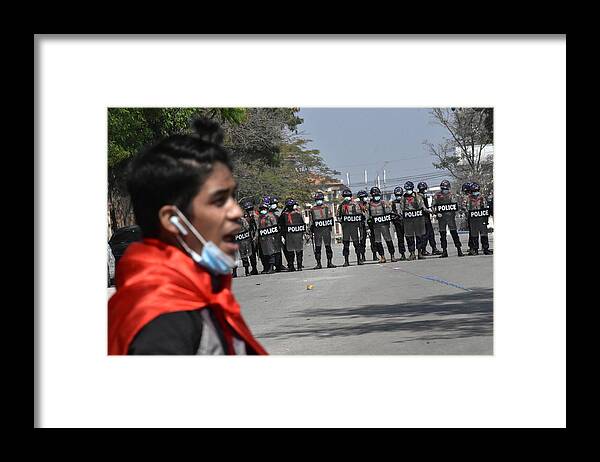 Police Framed Print featuring the photograph Protester defies policemen by Robert Bociaga