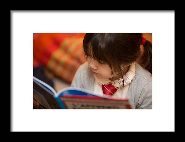 Child Framed Print featuring the photograph Reading a book by Benoist SEBIRE