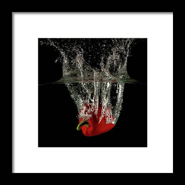 Pepper Framed Print featuring the photograph Red bell pepper dropped and slashing on water by Michalakis Ppalis