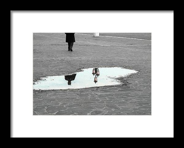 Puddle Framed Print featuring the photograph Reflection of a man in a puddle by Fabiano Di Paolo