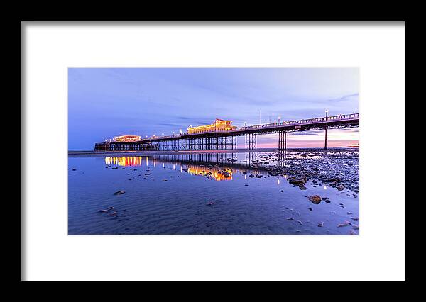 Beach Framed Print featuring the photograph Reflection of the pier at sunset by Andrew Lalchan