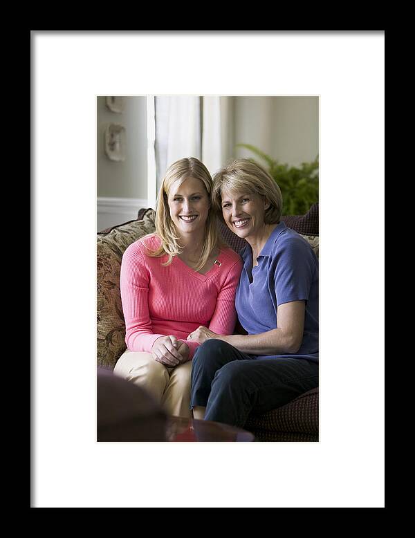 Adult Offspring Framed Print featuring the photograph Relationship Portrait Of A Young Adult Female As She Sits With Her Mother At Home by Photodisc