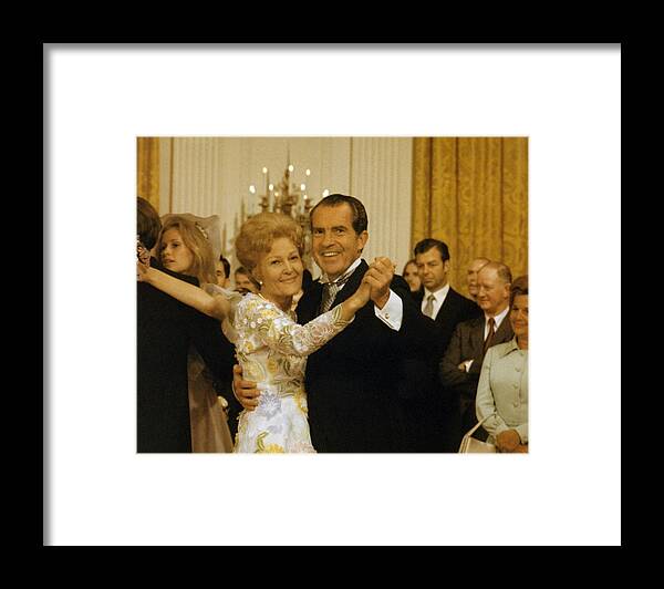 President Nixon Framed Print featuring the photograph Richard and Pat Nixon Dancing At The White House - 1971 by War Is Hell Store