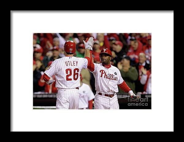 Philadelphia Phillies' Chase Utley (26), Jimmy Rollins (11) and Ryan Howard  (6) celebrate the Phillies' 8