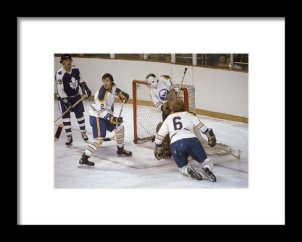 Paul Henderson Framed Print featuring the photograph Sabres Defend Their Net Against The Leafs by Melchior DiGiacomo