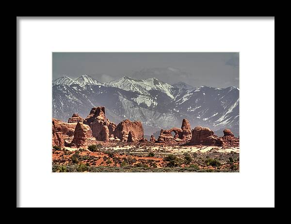 Arches Framed Print featuring the photograph Sandstone formations and Turret Arch vista in Arches National Park with La Sal mountains behind by Peter Herman