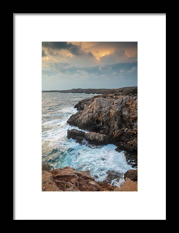 Stormy Sea Framed Print featuring the photograph Seascape with windy waves during stormy weather at sunset. by Michalakis Ppalis
