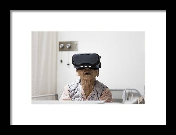 Augmented Reality Framed Print featuring the photograph Senior woman in the hospital wearing a Virtual Reality headset by Kohei Hara