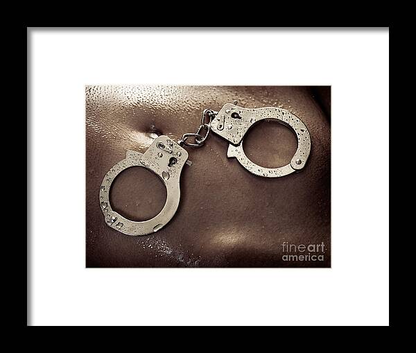 Handcuffs Framed Print featuring the photograph Shiny handcuffs on wet naked woman body by Maxim Images Exquisite Prints