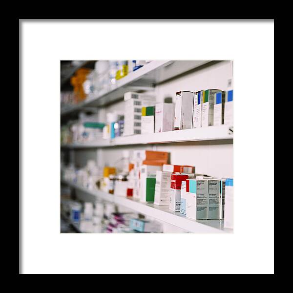 Pharmacy Framed Print featuring the photograph Side View Of Rows Of Medicines On A Shelf by George Doyle