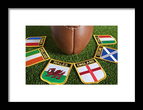 Event Framed Print featuring the photograph Six different nation's badges for rugby around a rugby ball by Stocknshares