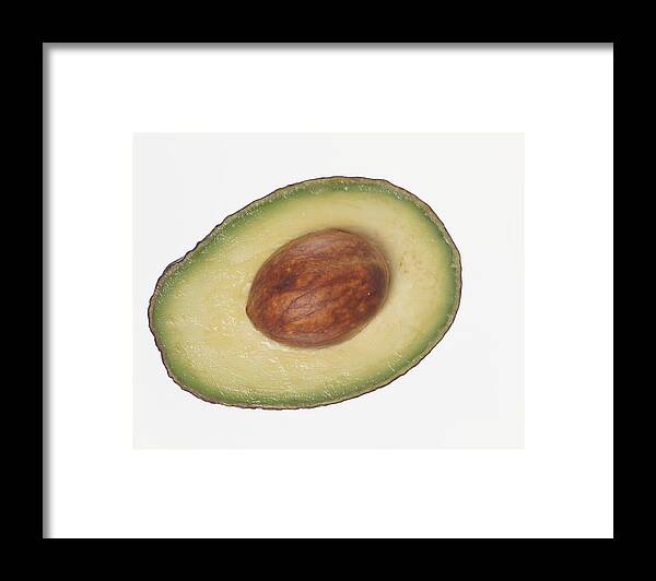 White Background Framed Print featuring the photograph Slice of Avocado Containing a Seed by Digital Vision.
