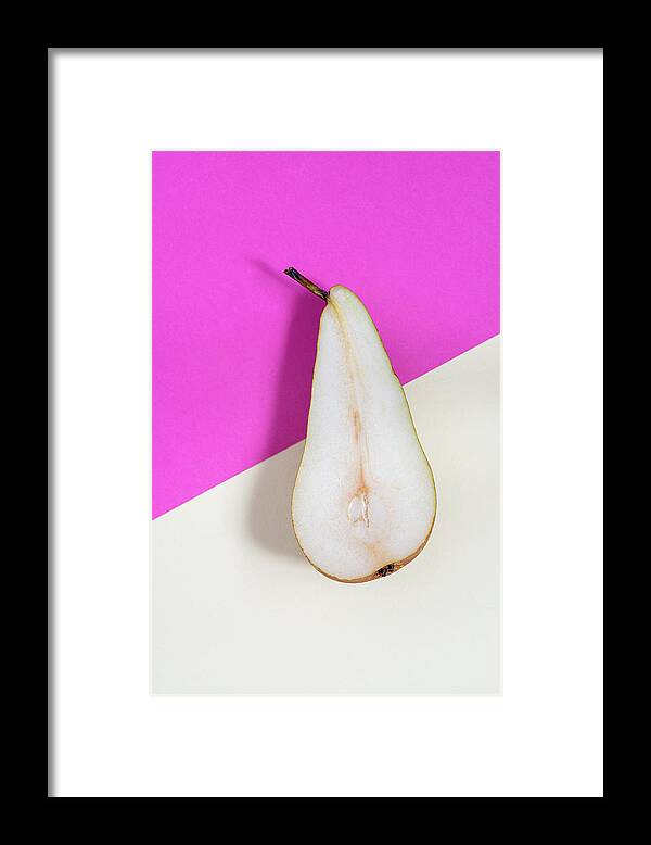 Still-life Framed Print featuring the photograph Slice of healthy pear fruit on a colourful background. by Michalakis Ppalis