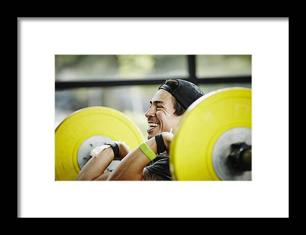 Toughness Framed Print featuring the photograph Smiling man preparing to press barbell over head by Thomas Barwick