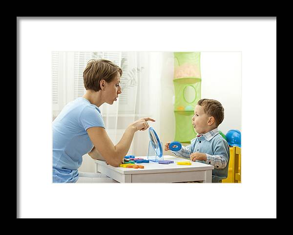 Mid Adult Framed Print featuring the photograph Speech Therapist With Child by Jaroon