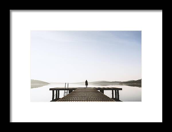 People Framed Print featuring the photograph Standing on the seaside jetty by Ekin Kizilkaya